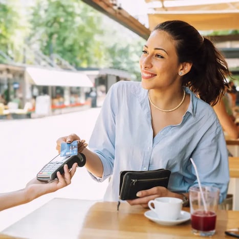 Woman tapping to pay at Point of Sale