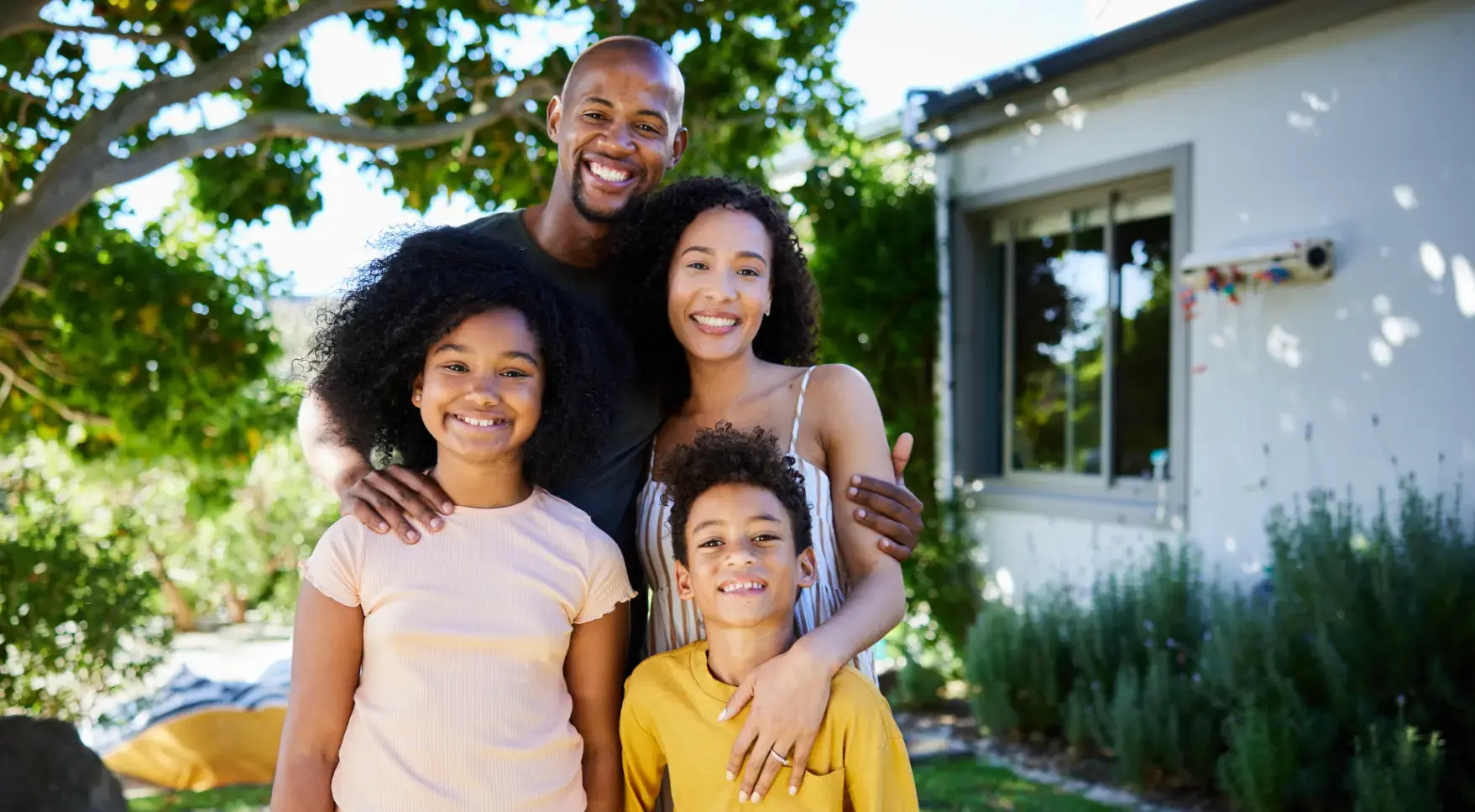 Family stood infront of a house